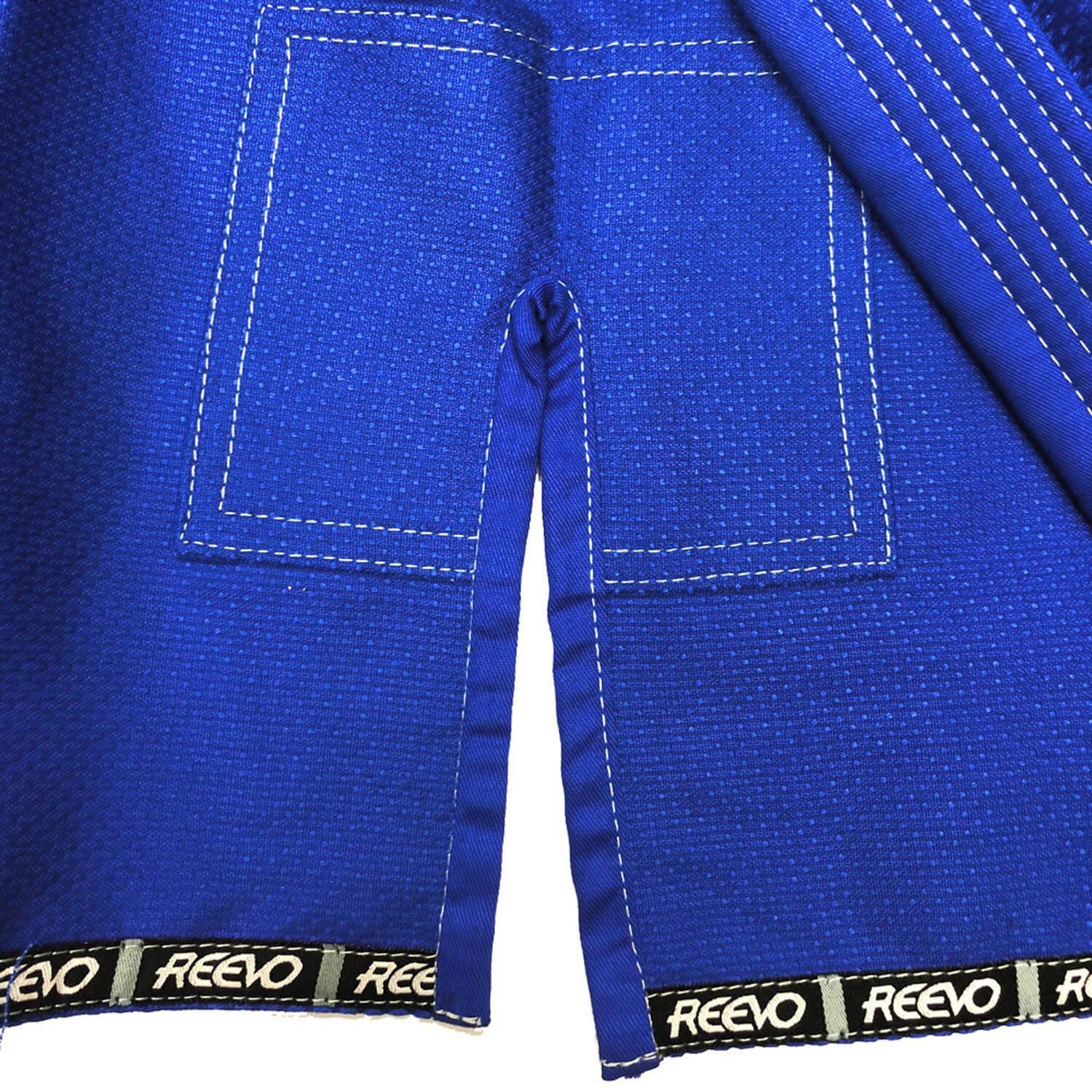 Close-up of a blue martial arts uniform with REEVO branding on the waistband.