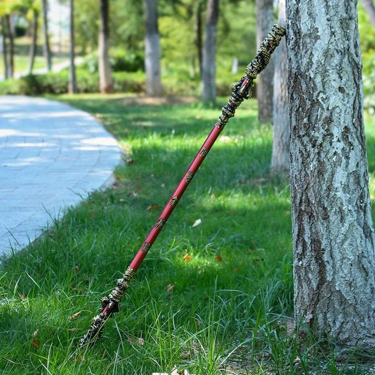 Sun Wukong Stick leaning against a tree in a park setting