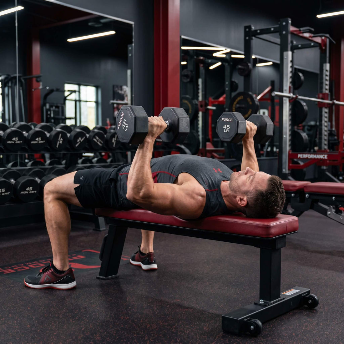 A man doing chest work out with 2 dumbbells