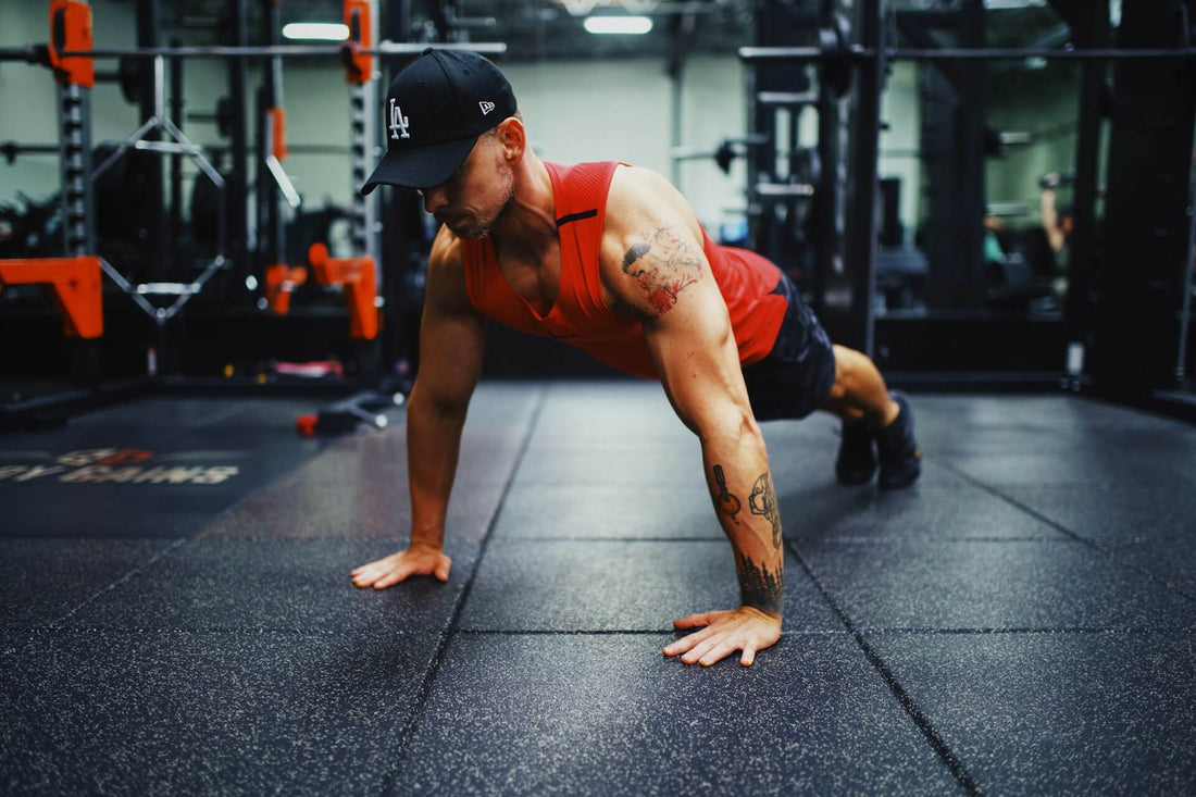 A man doing push up variations in the gym
