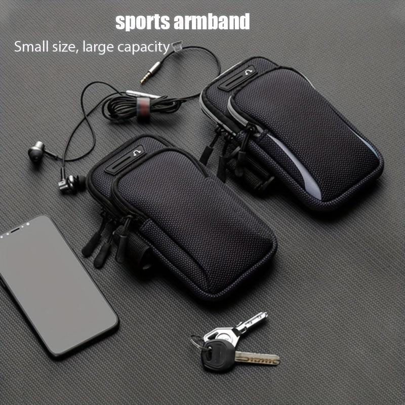 Black sports armband with phone, keys, and earbuds on a gray surface