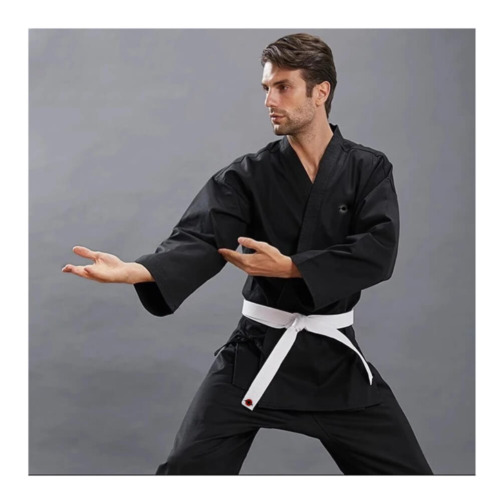 A man wearing a black 14oz Heavyweight Karate Gi sold by 100 Spartans