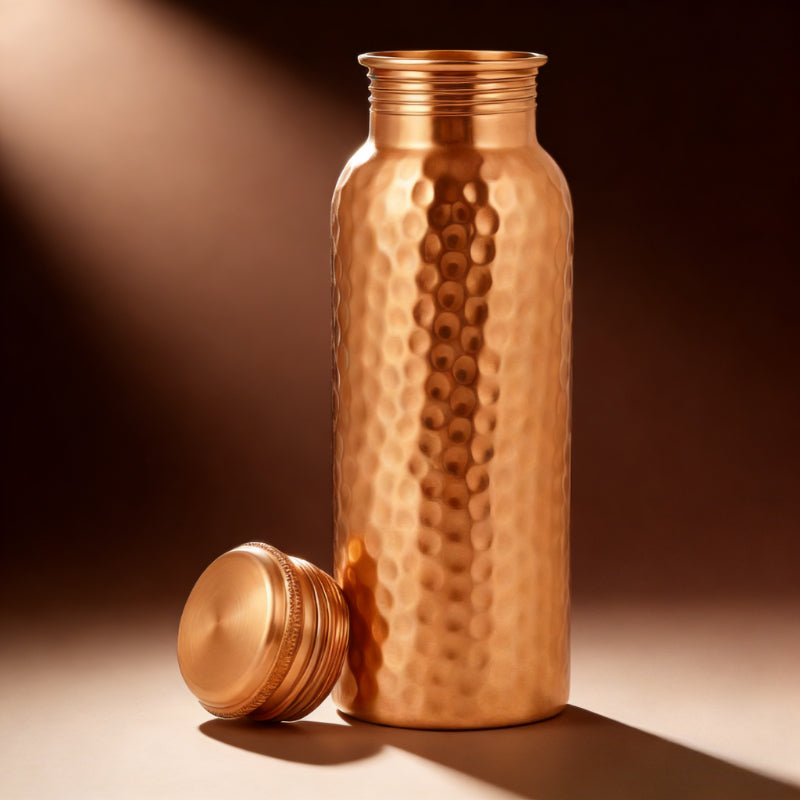 Copper water bottle with a textured surface on a brown background