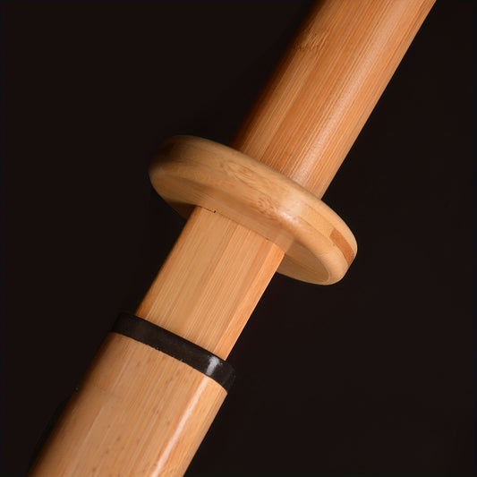 Close-up of a wooden training sword handle with a dark background