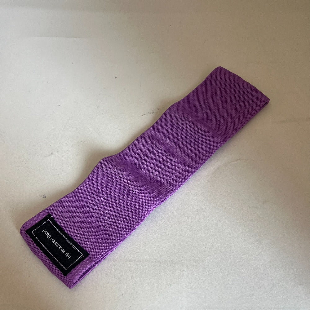 Purple wrist wrap on a light beige surface with a visible brand label.