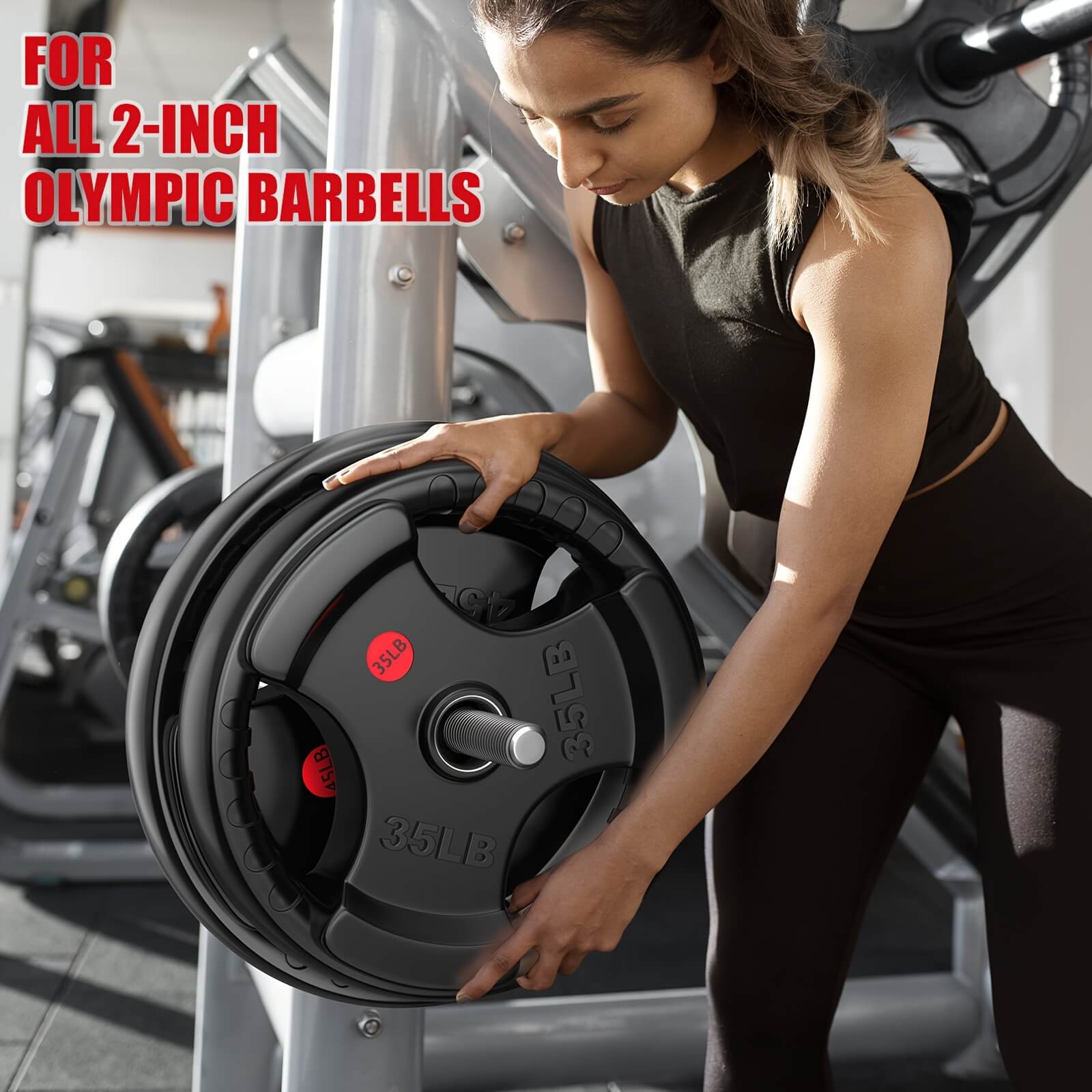 Woman lifting weight plates in a gym setting.