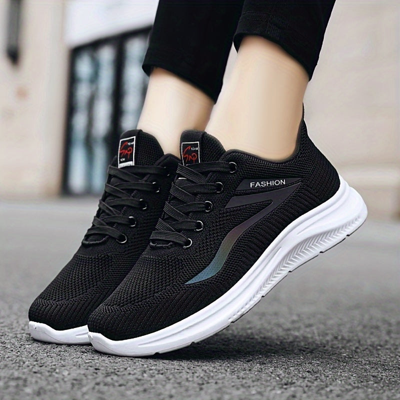 Black running shoes with white soles worn by a person on a blurred background