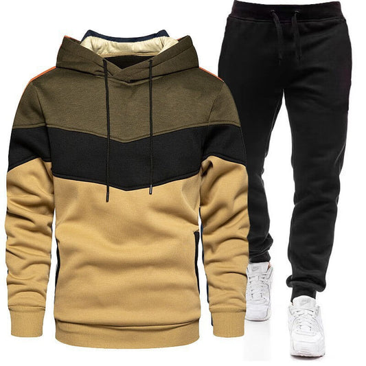 Color-blocked hoodie and black pants with white sneakers on a white background