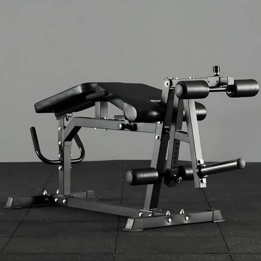 Black leg exercise machine on a dark tiled floor with a gray background