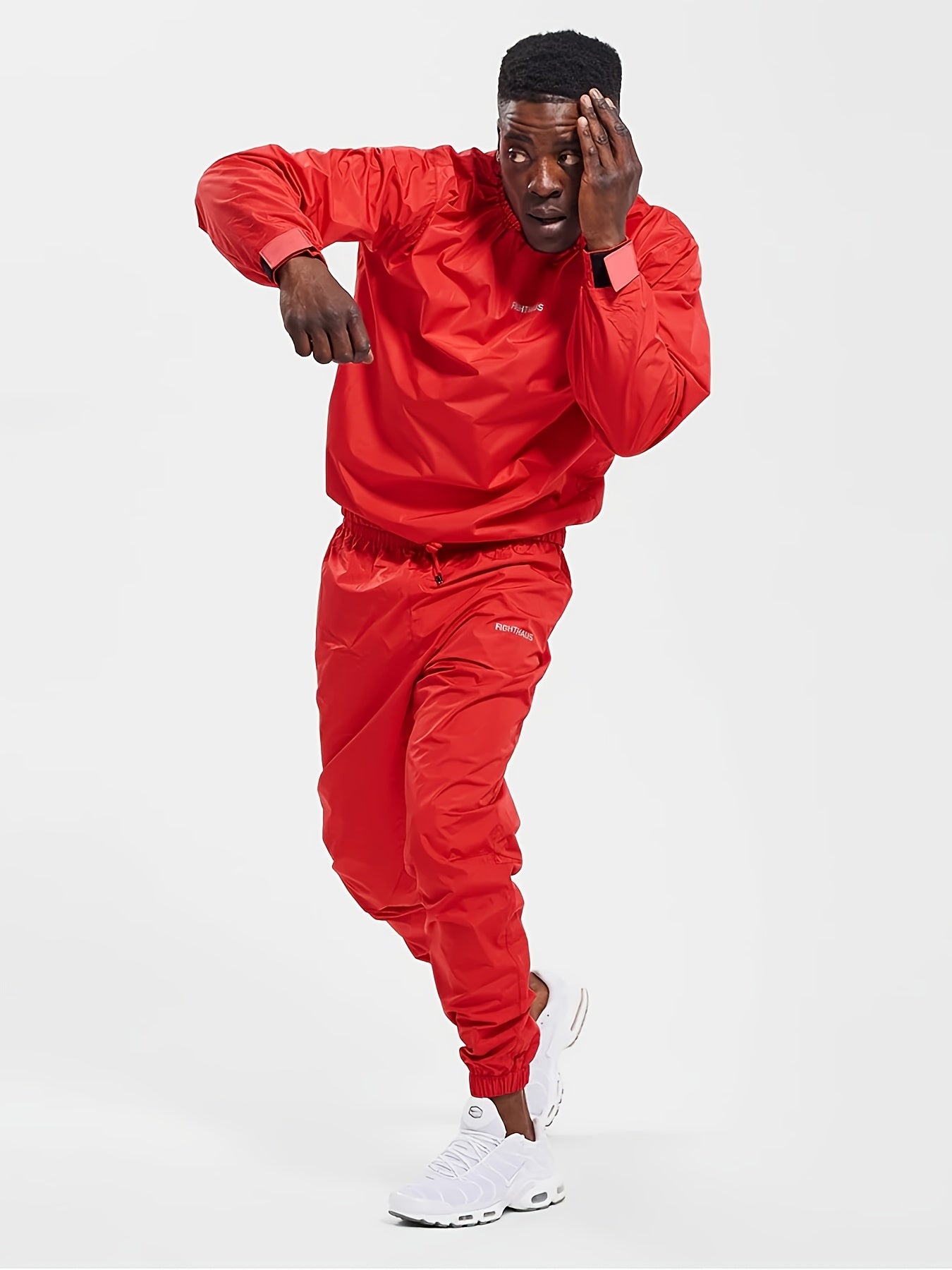 Person wearing a red mens sauna sweat suit on a white background