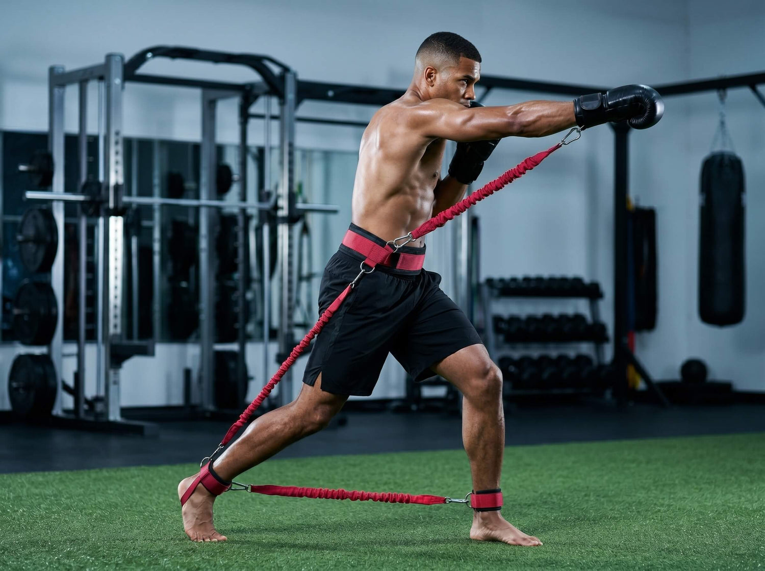 A boxer using resistance bands in a gym setting