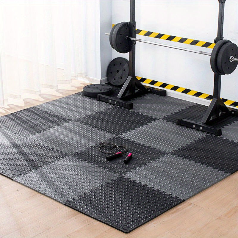 Gym floor with interlocking foam mats and weightlifting equipment.