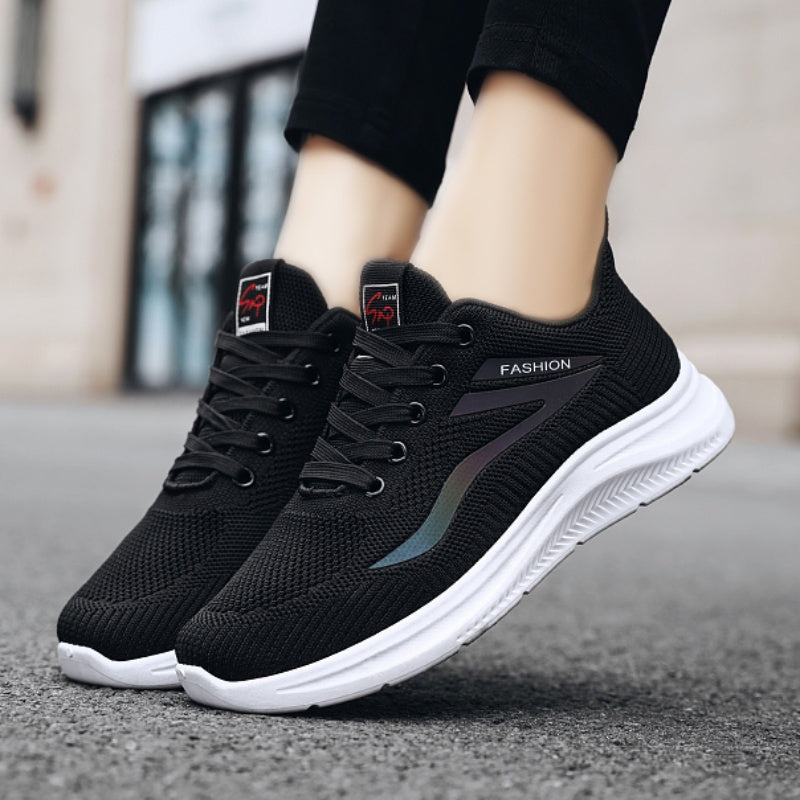 Black running shoes with white soles on a blurred background