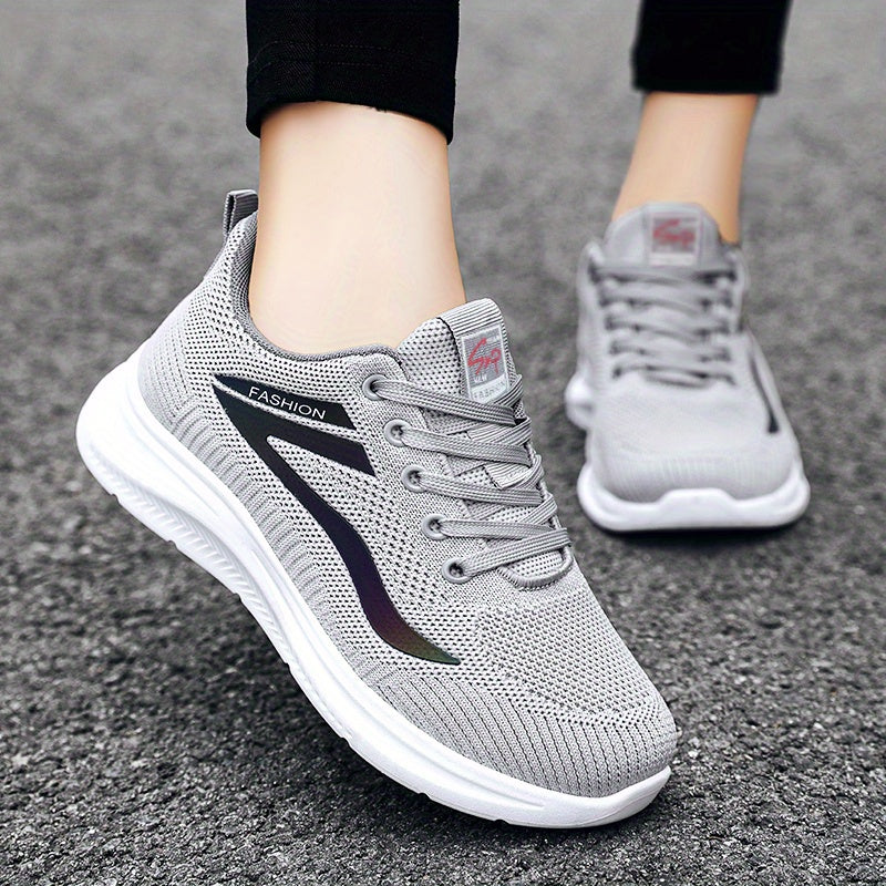 Gray athletic shoes on a person's feet with a blurred background