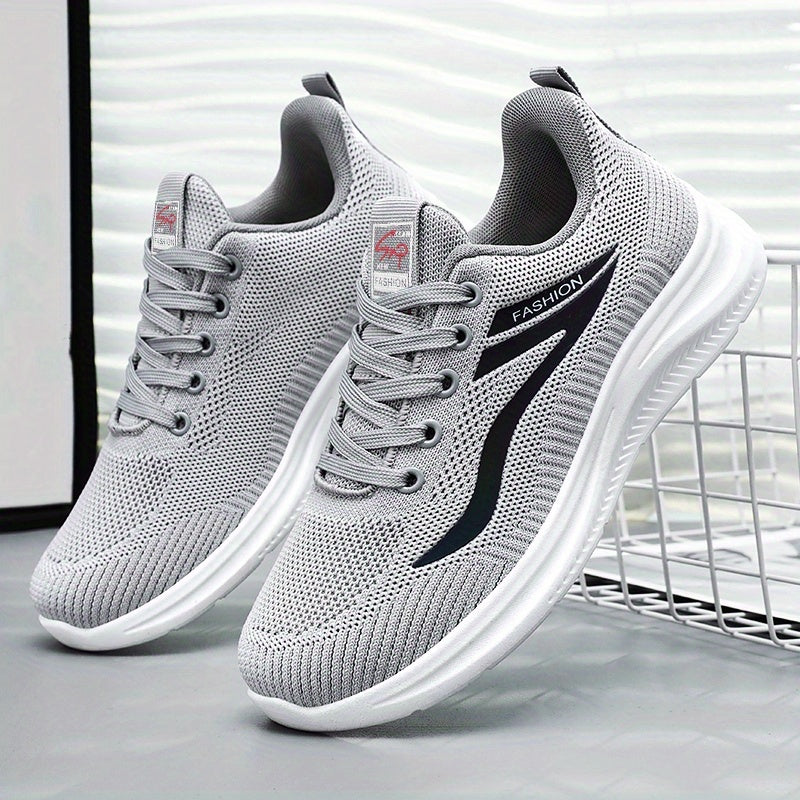Gray running shoes with white soles on a light gray background