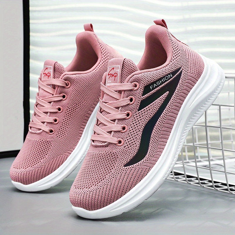 Pink running shoes with white soles on a light gray surface.