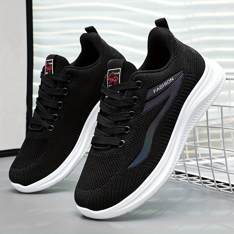 Black running shoes with white soles on a light gray background