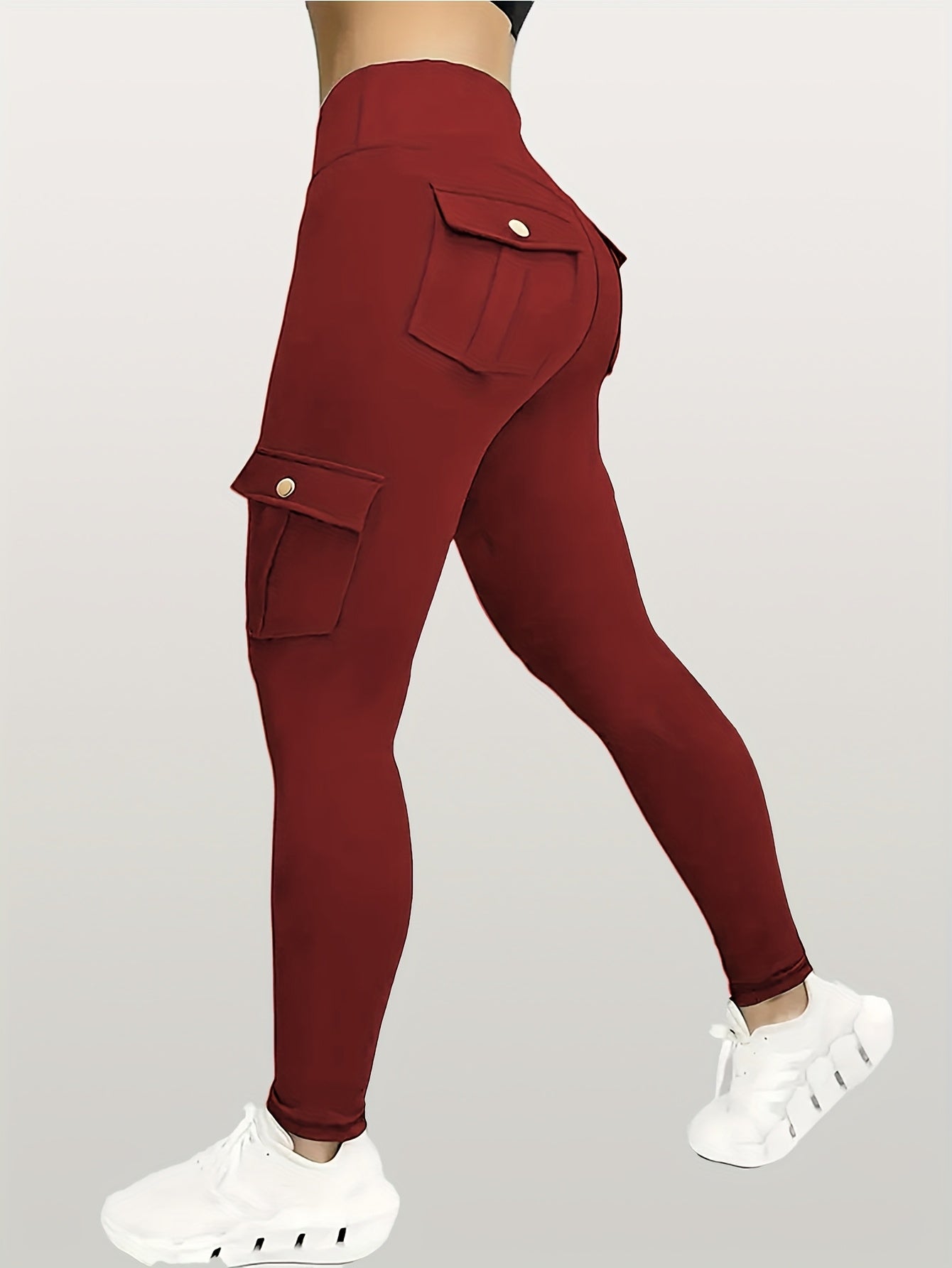 Maroon cargo pants with white sneakers on a gray background