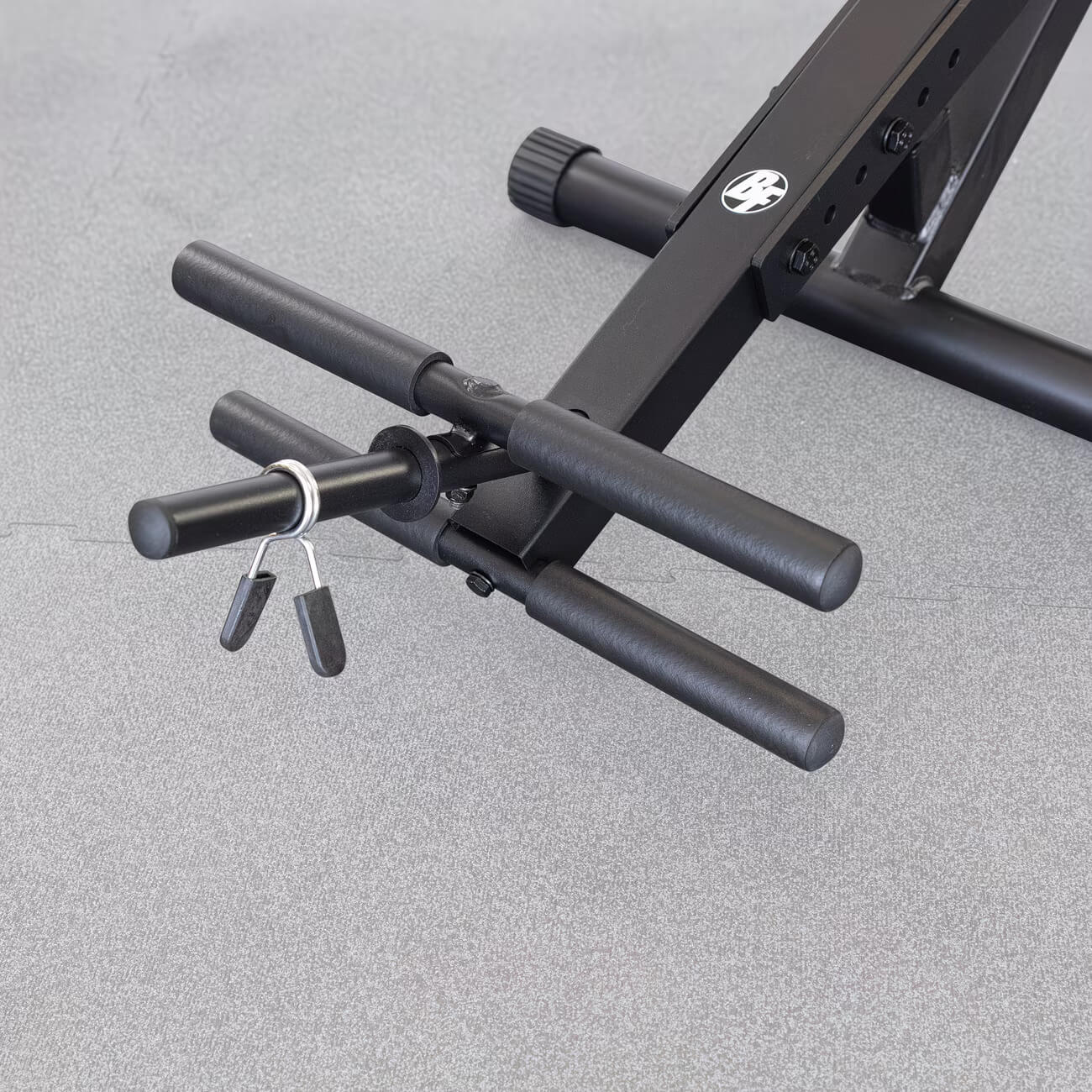 A black semi-recumbent ab bench bar on a gray floor