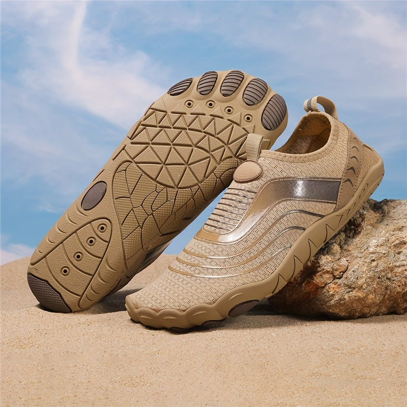 Beige water hiking shoes with textured soles on a sandy background