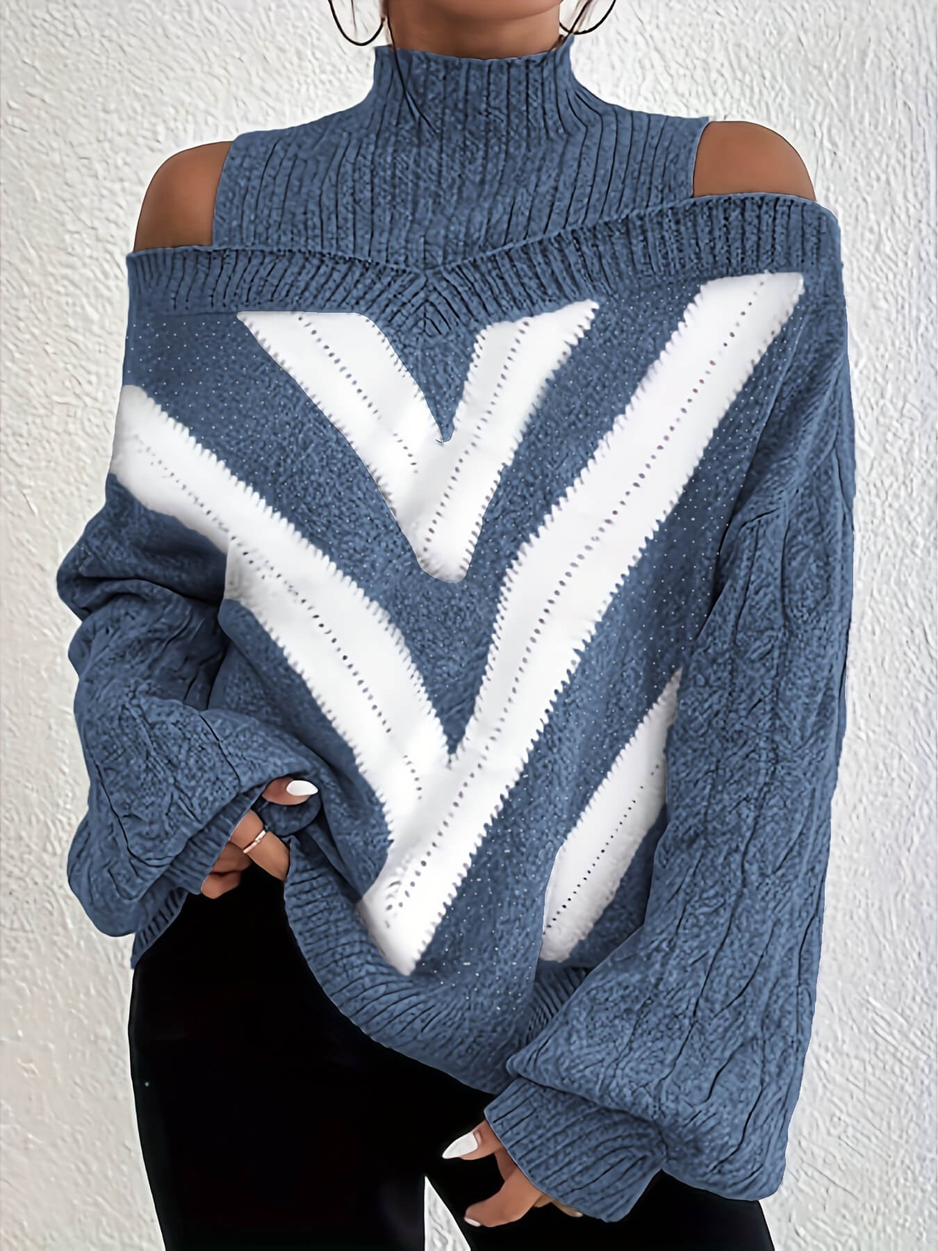 Blue and white off the shoulder sweater with cold shoulder design on a plain background
