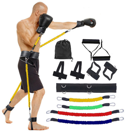 Man exercising with resistance bands and accessories on a white background
