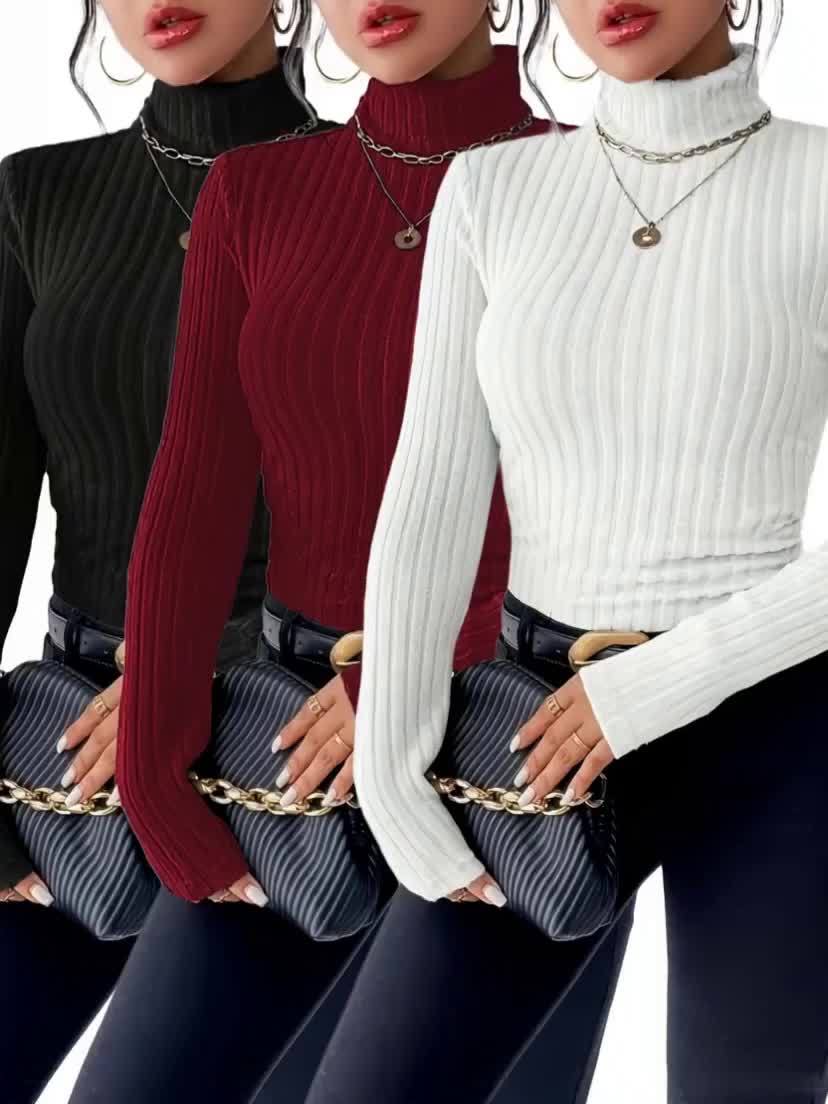 Three women wearing turtleneck sweaters in black, red, and white, holding gold handbags.