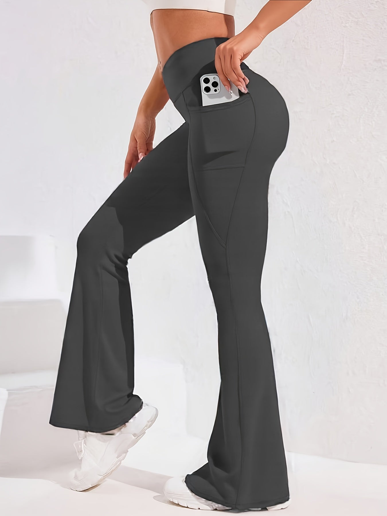 A woman wearing a grey women’s flare leggings sold by 100 Spartans