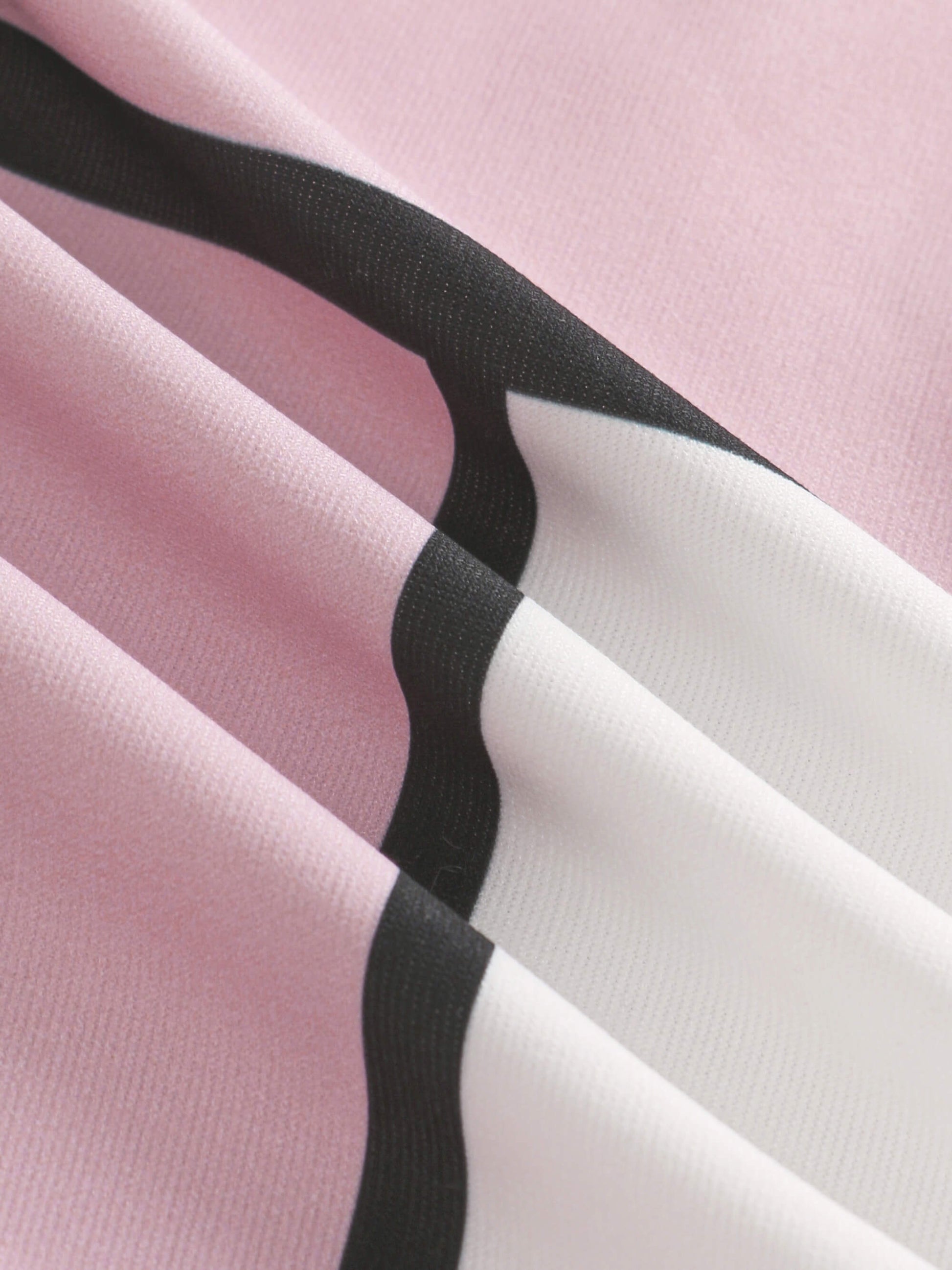 Close-up of pink fabric with black and white stripes