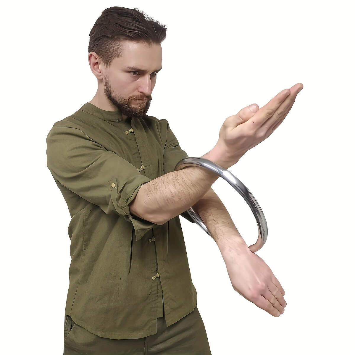 A man in olive green shirt training with a wing chun ring on his arm against a white background