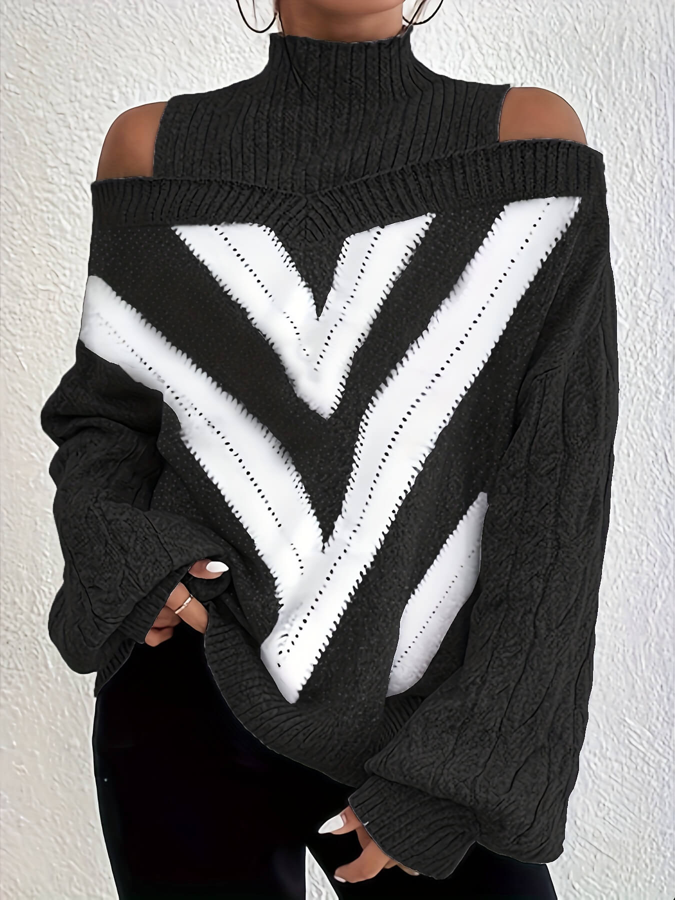 Green off the shoulder sweater with white V-shaped design on a plain background