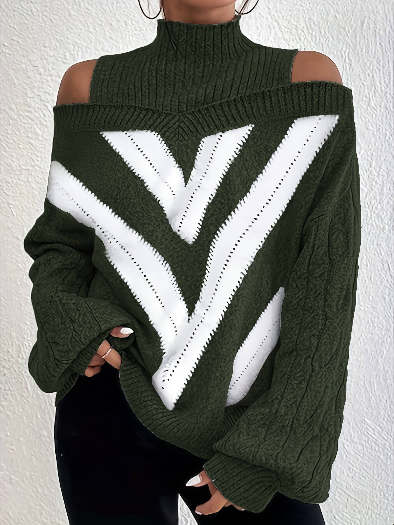 Green off the shoulder sweater with white geometric pattern on a wooden surface