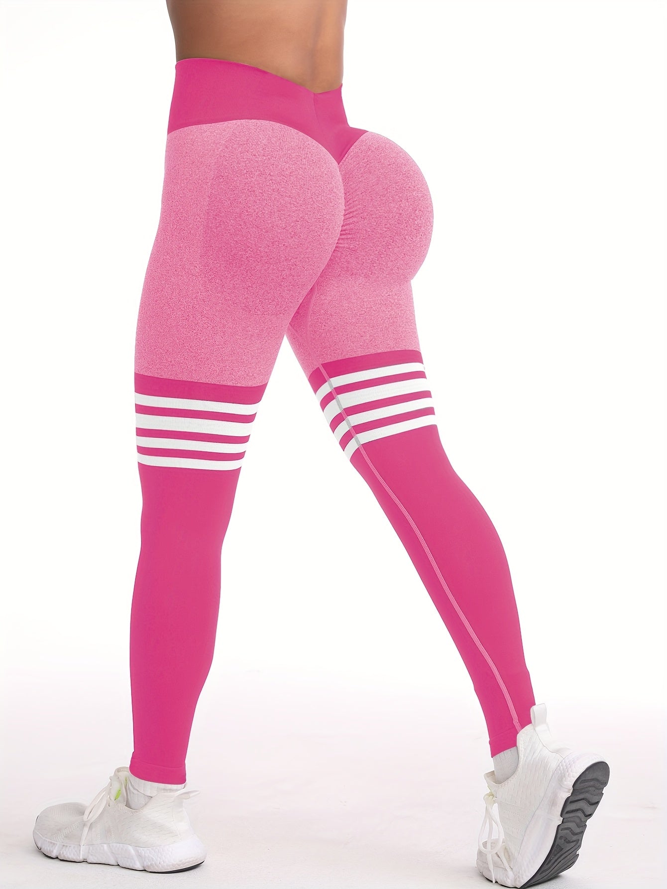 The back view of a woman wearing a pink yoga legging sold by 100 Spartans