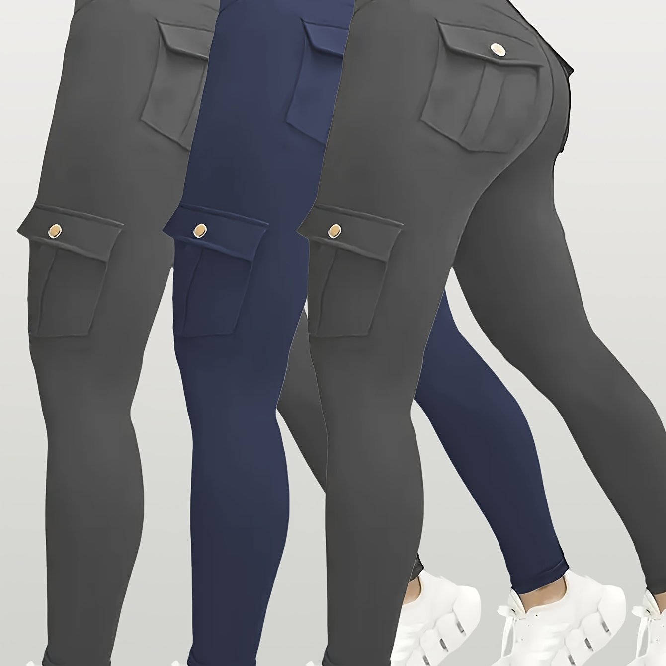 Navy and gray yoga leggings with button details on a light gray background