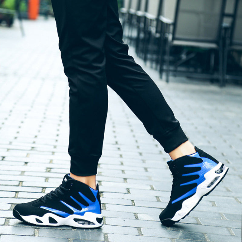 Person wearing black and blue athletic shoes on a paved surface