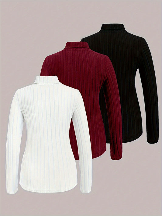 Three ribbed knit shirts in white, red, and black on a light pink background