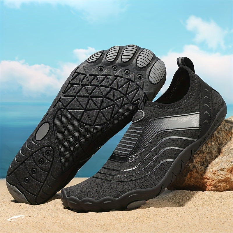 Black water hiking shoes with textured sole on a beach background