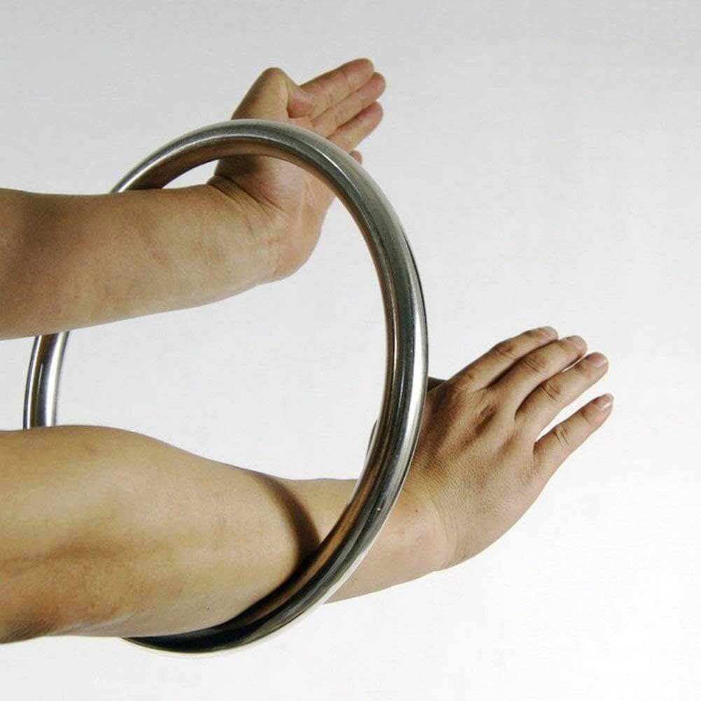 A person training with a wing chun ring with a plain background