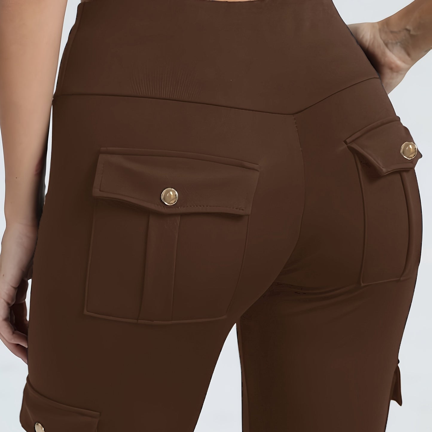 The back view of a woman wearing a pair of brown yoga legging sold by 100 Spartans