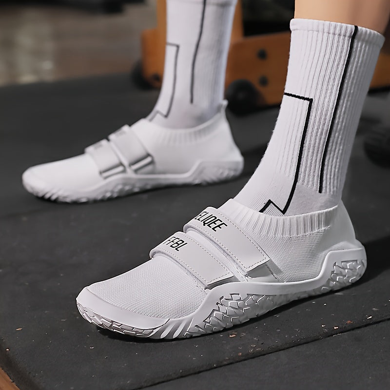 White shoes for lifting weights with black accents worn on a dark surface