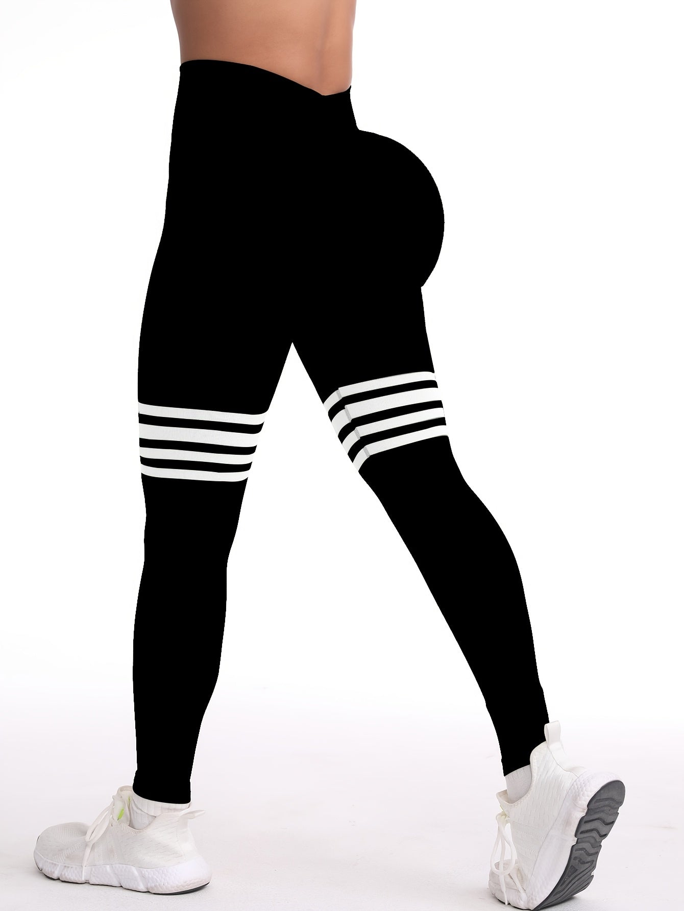 The back view of a woman wearing a black yoga legging sold by 100 Spartans
