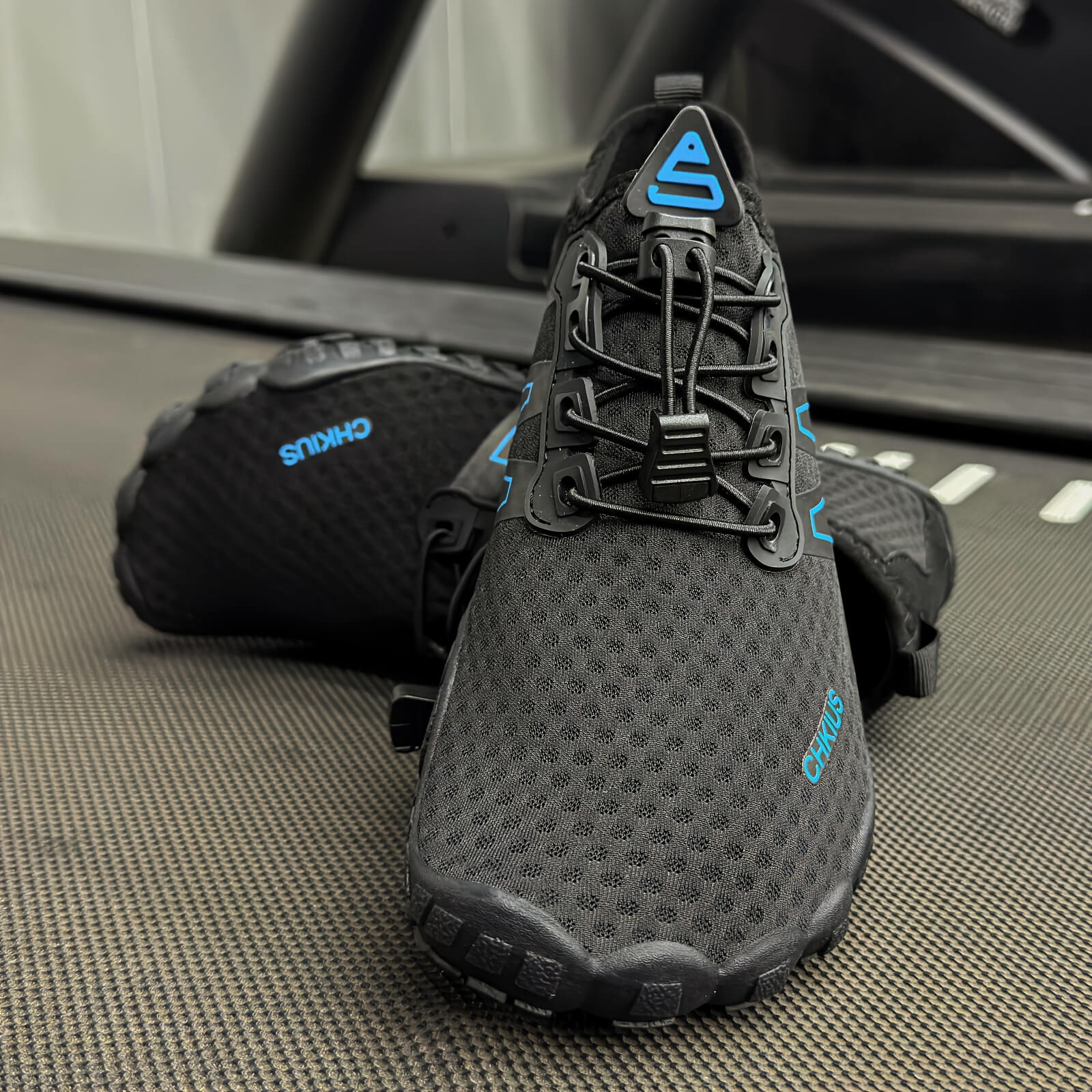 Black and blue deadlift shoes on a textured surface