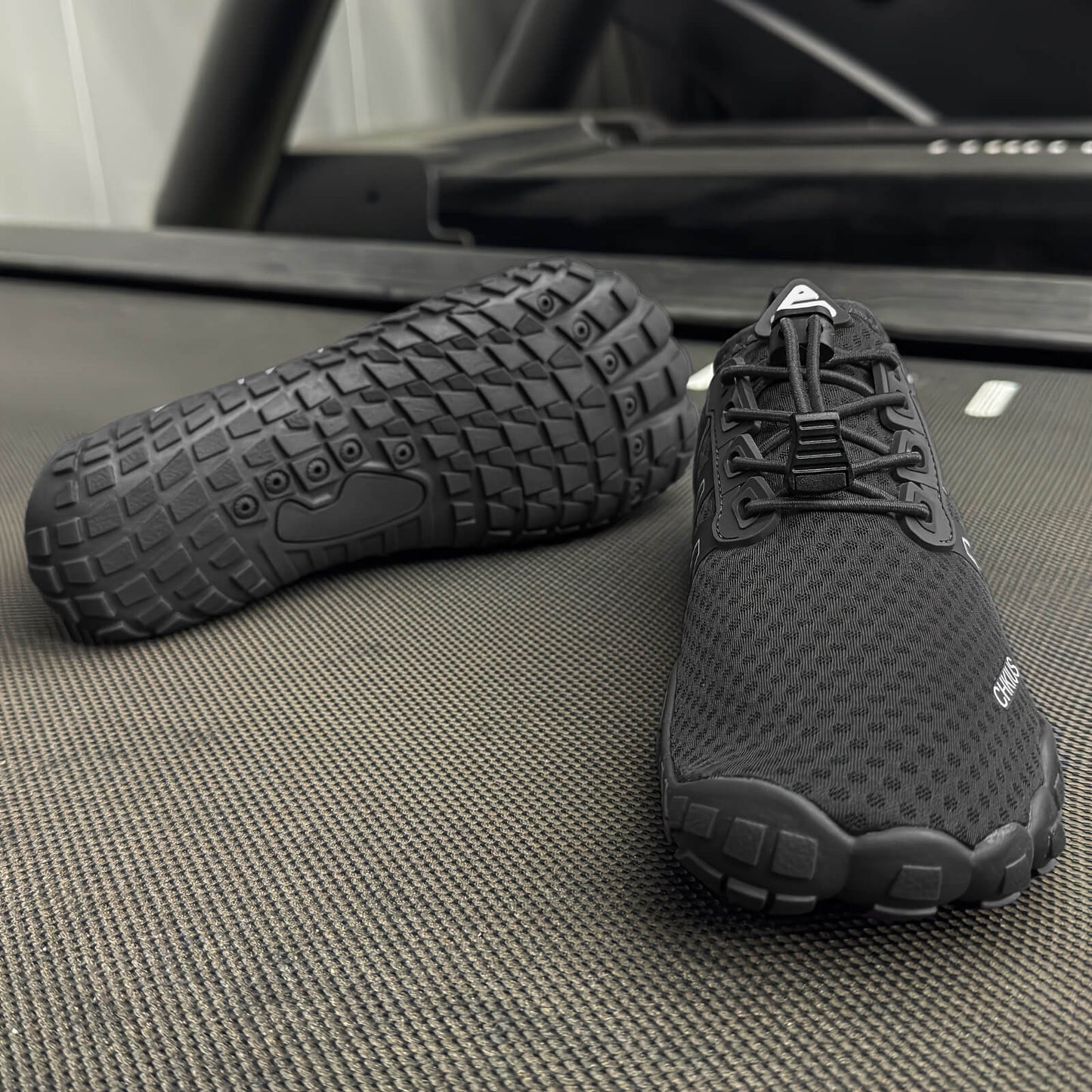 Black deadlift shoes on a textured surface