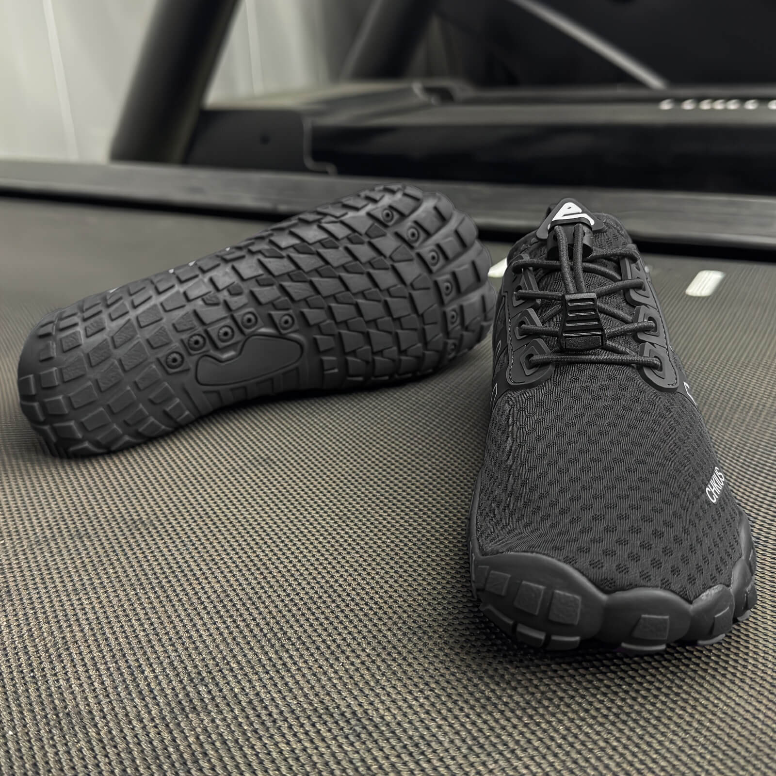 Black deadlift shoes on a textured surface