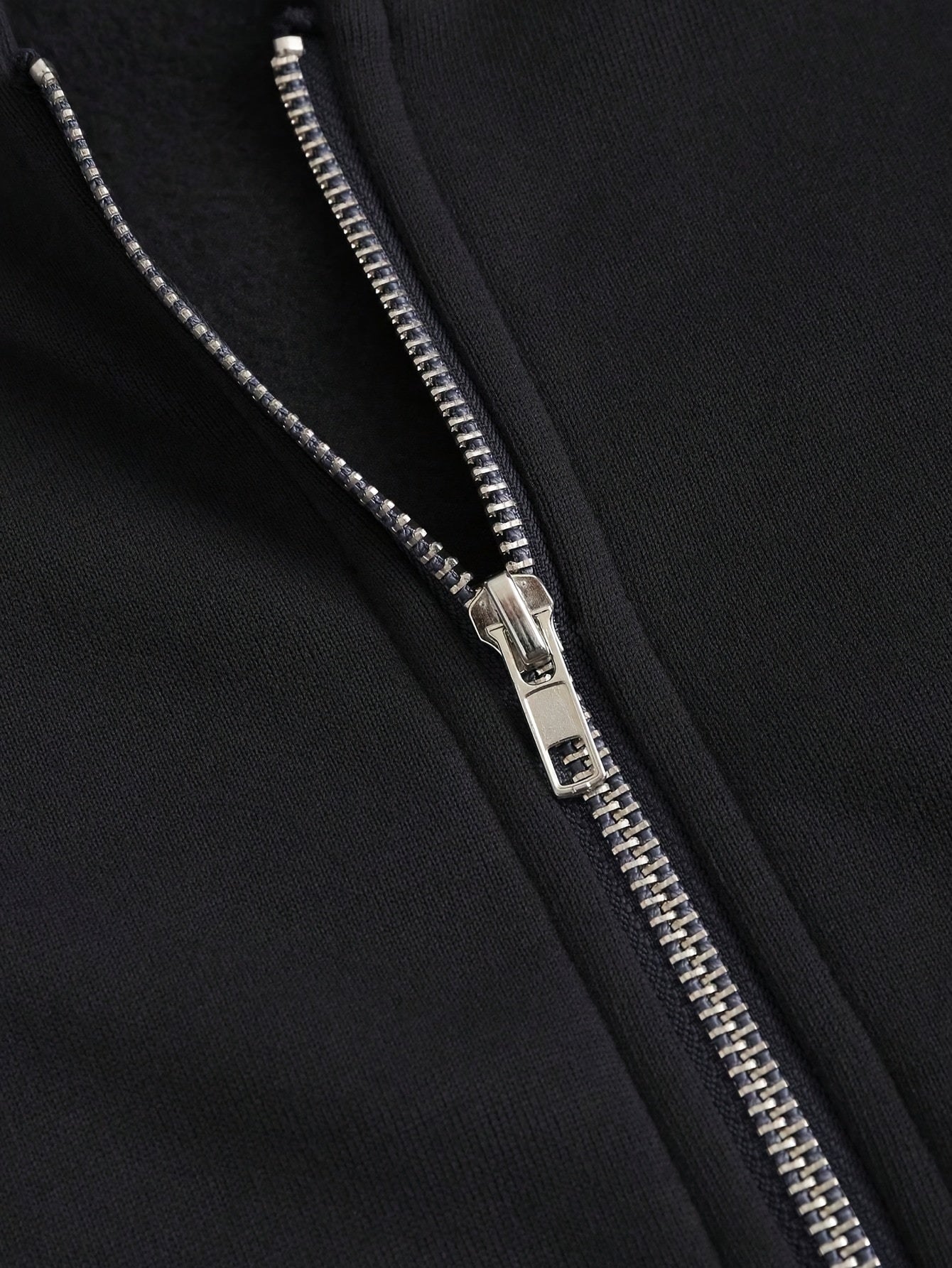 Close-up of a women’s hooded zip-up sweatshirt sold by 100 Spartans