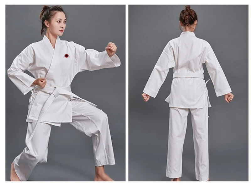 A woman wearing a white 14oz Heavyweight Karate Gi sold by 100 Spartans