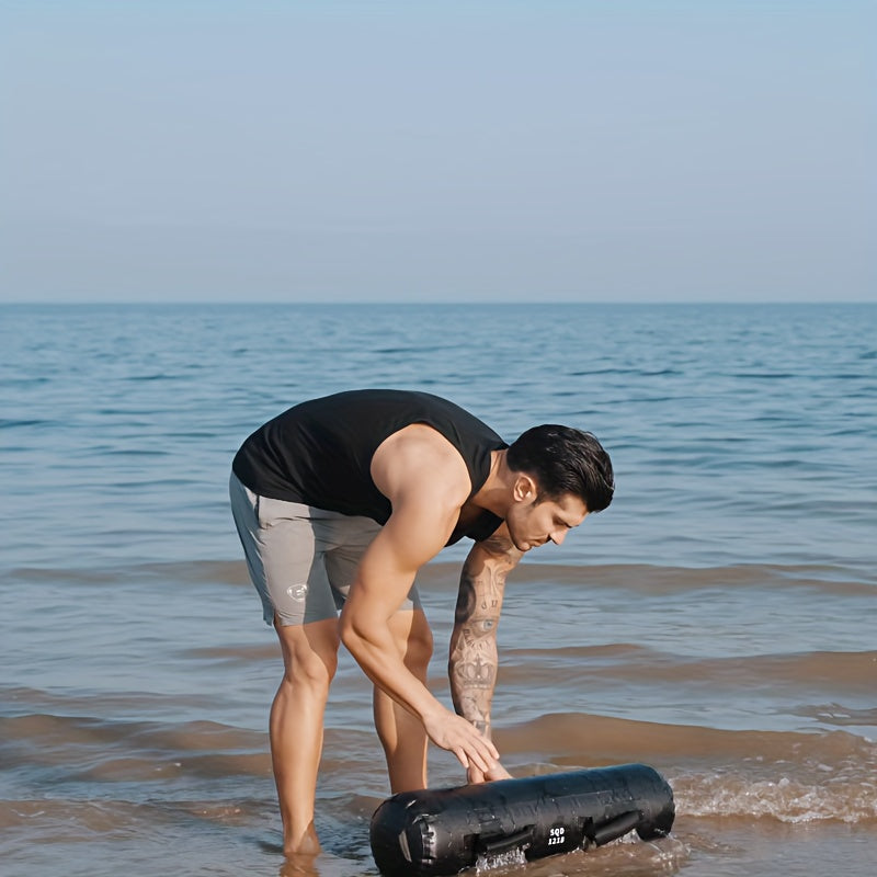 A man filling up a water weight bag​ with water from the ocean