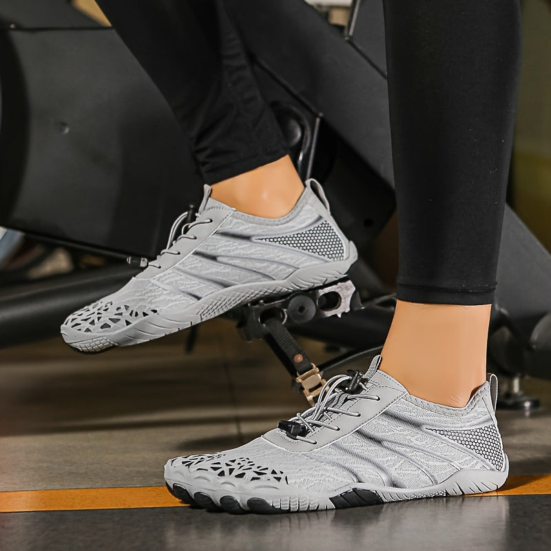 Gray deadlift shoes worn by a person sitting on a gym machine.