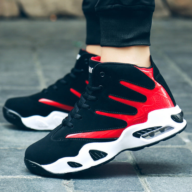 Black and red sneakers with white soles on a pavement background