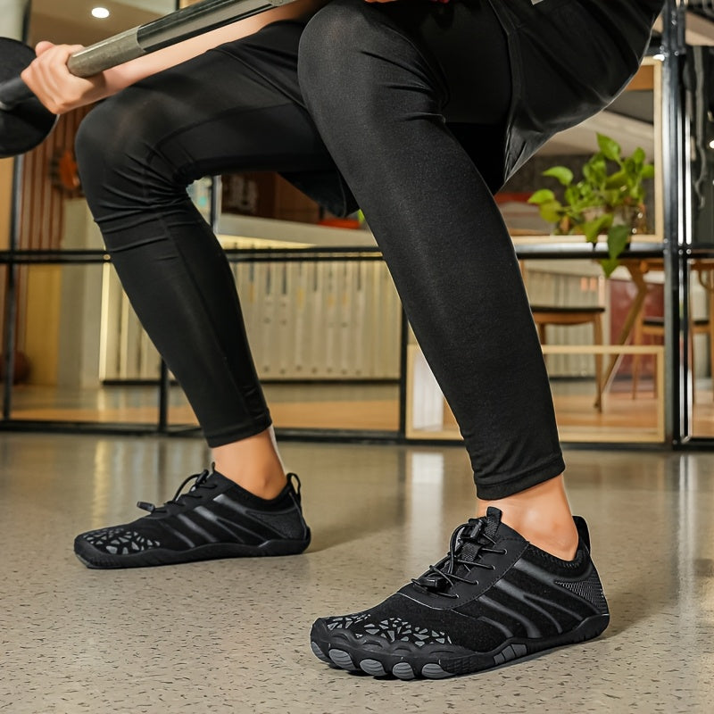 Person wearing black deadlift shoes and leggings sitting on a chair indoors.